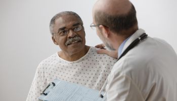 African man talking to doctor