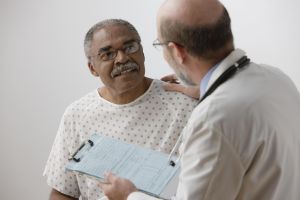 African man talking to doctor