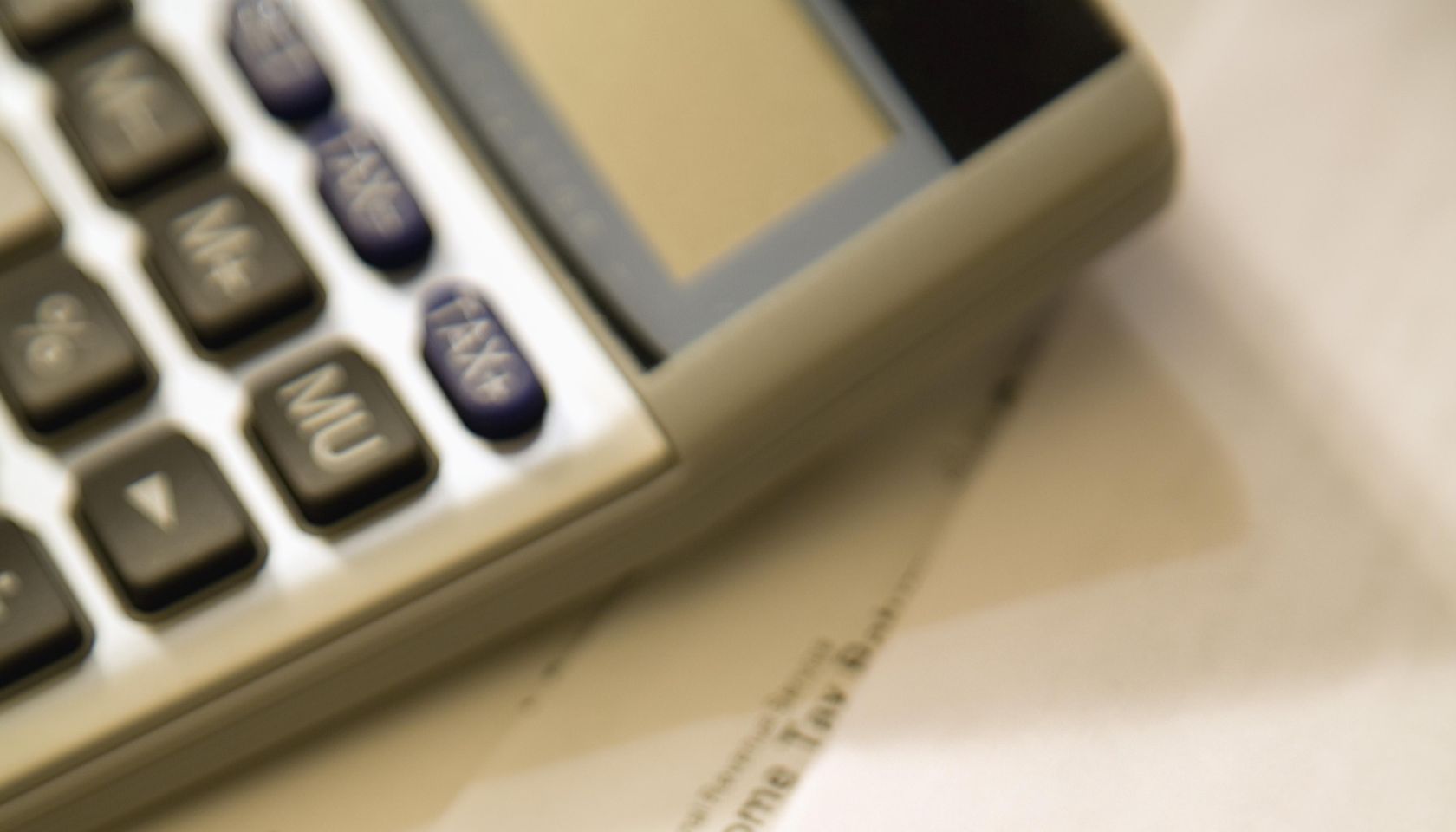 Tax forms with pencil and calculator