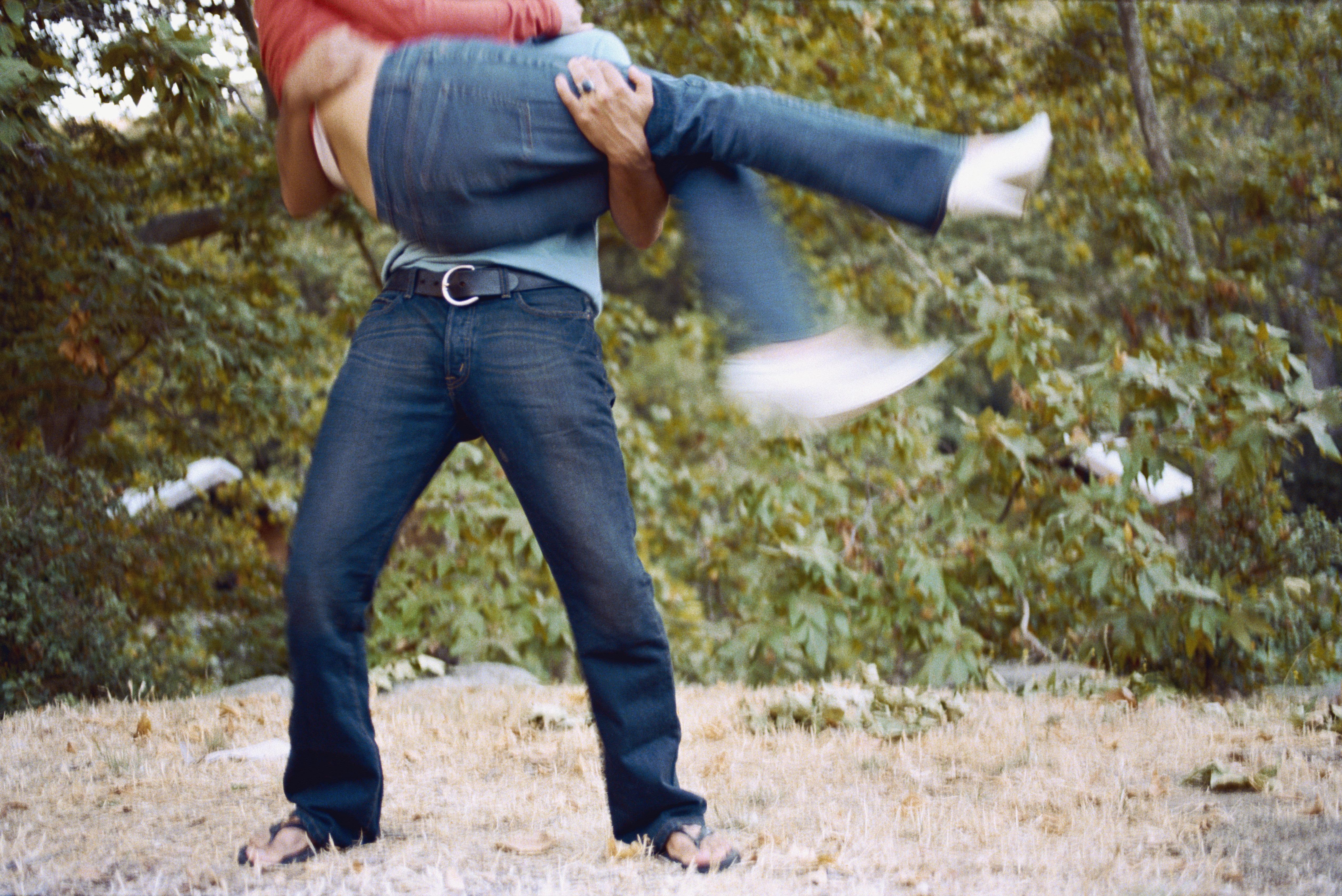 Man lifts and holds woman