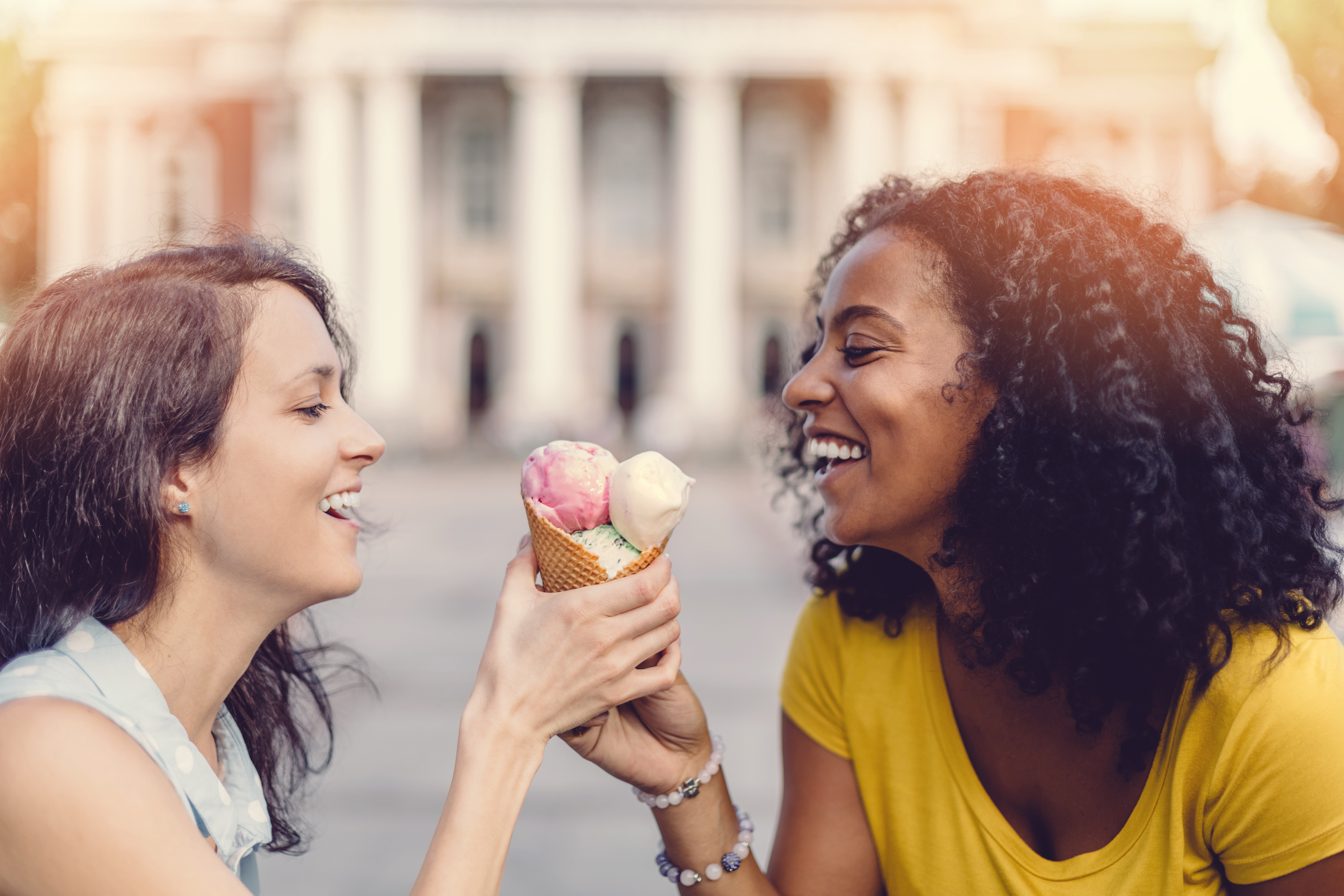 Happy girls sharing an ice cream