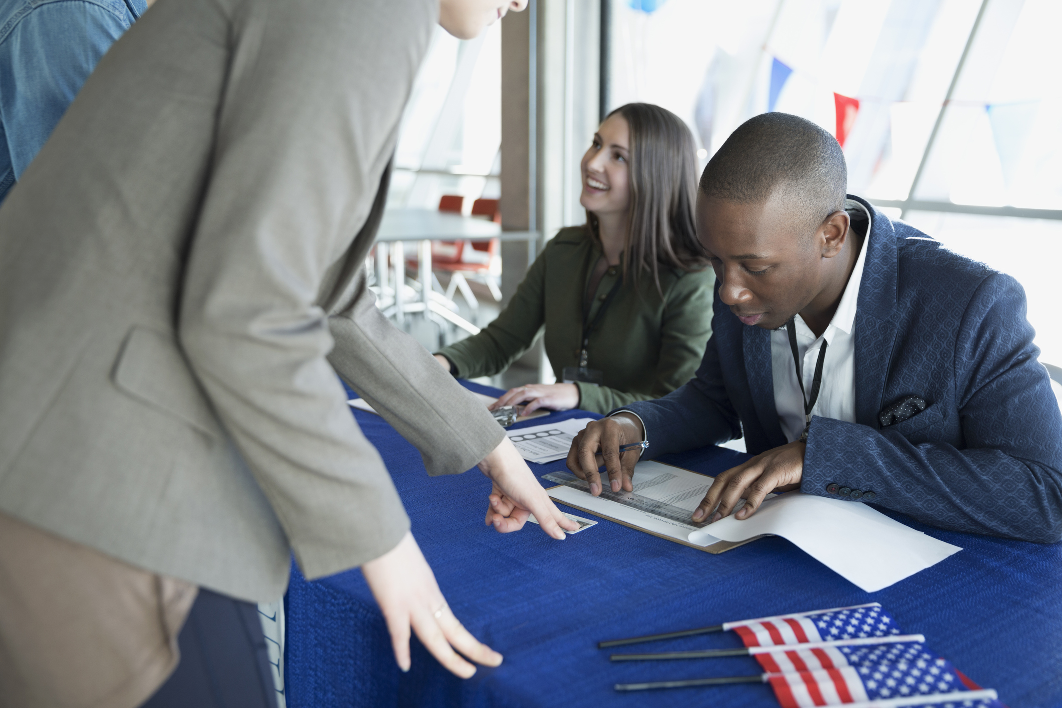 Volunteers checking voters in at polling place