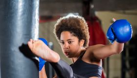 Young african woman training at gym, boxing