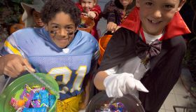 Children (4-8) in Halloween costumes trick-or-treating, elevated view