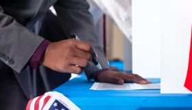 Man's hands while voting in election vote booth