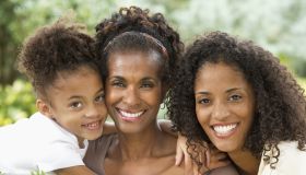 Three generations of women smiling together