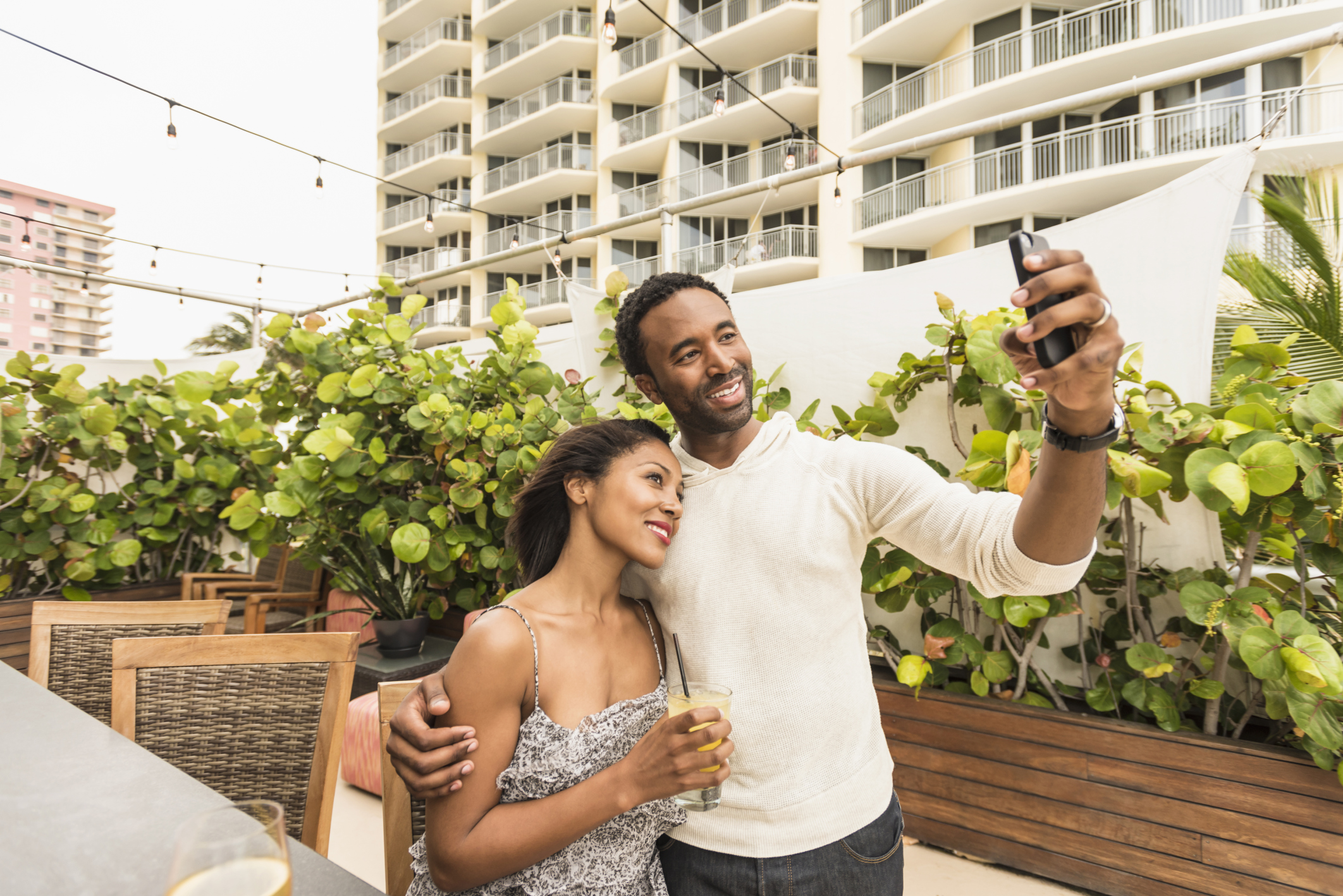 Couple taking selfie on urban rooftop