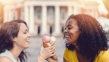 Happy girls sharing an ice cream