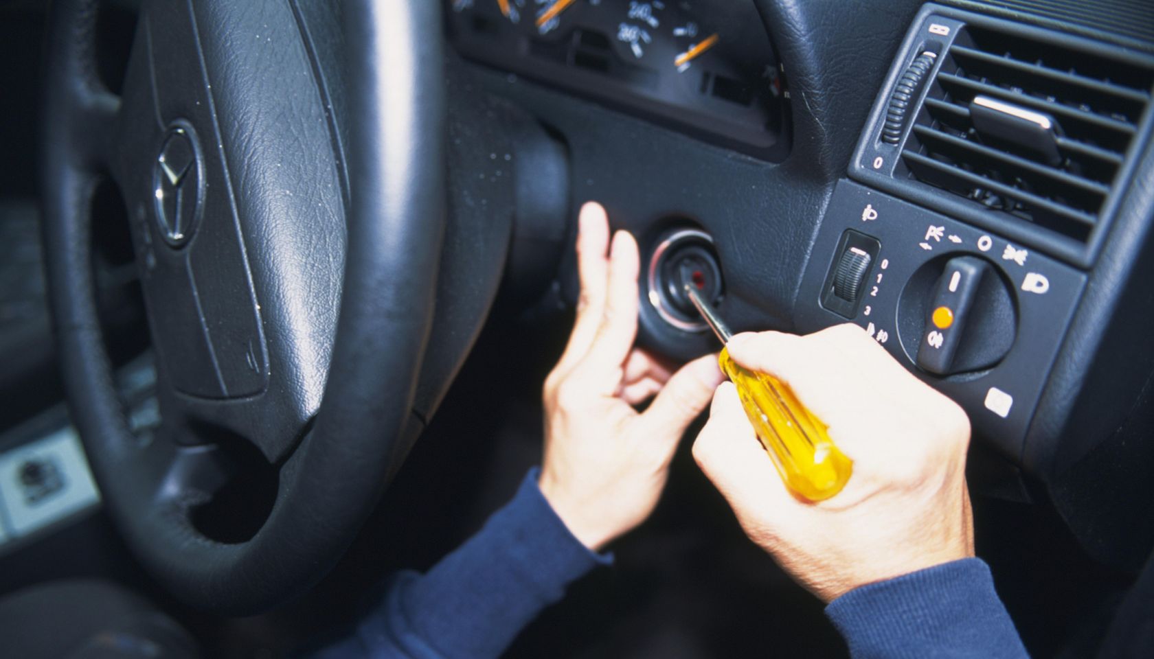 Photography of hands breaking into a car, High Angle View