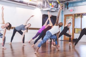 Group of Women Doing Barre + TRX Workout