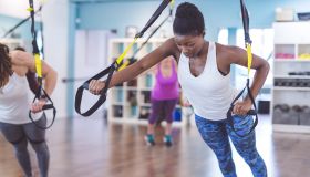 Group of Women Doing Barre + TRX Workout