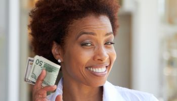 African American woman holding 50 dollar bill