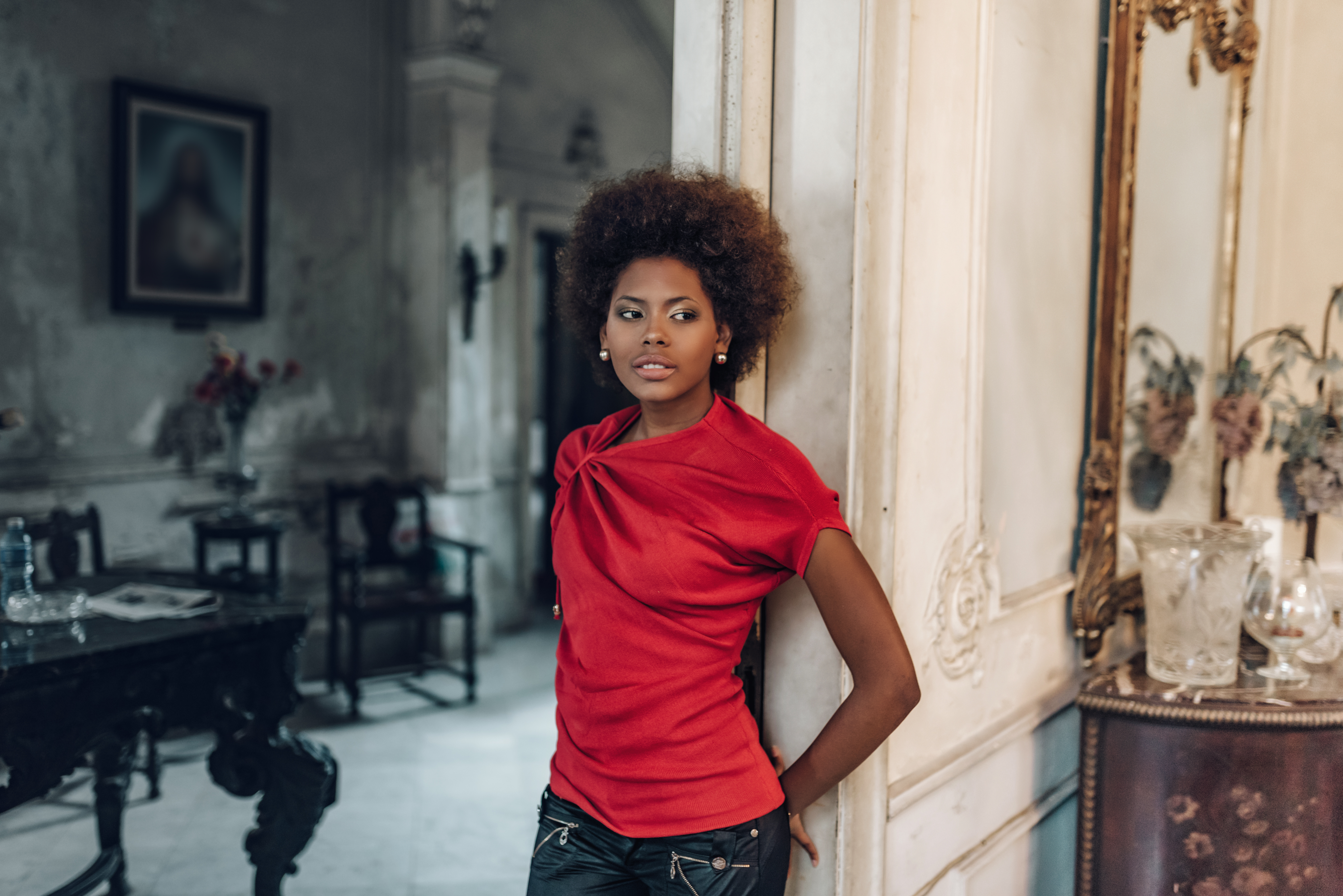 beautiful young cuban woman leaning on door in old havanna house
