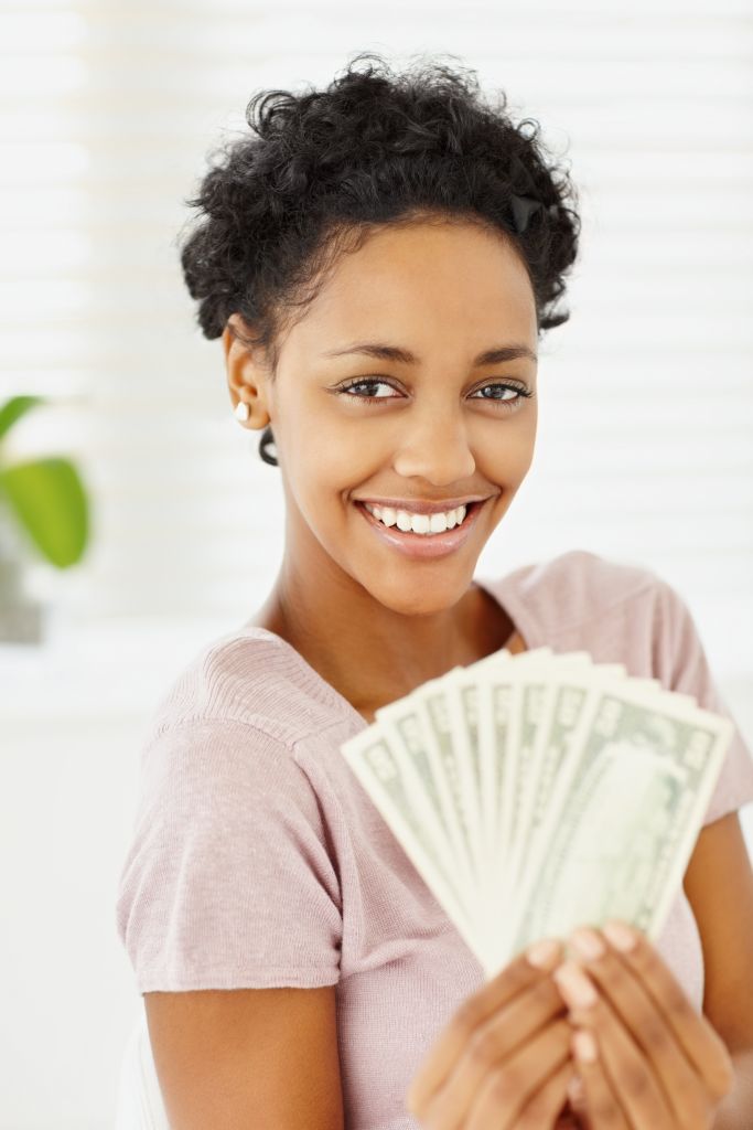 Happy young lady holding currency notes