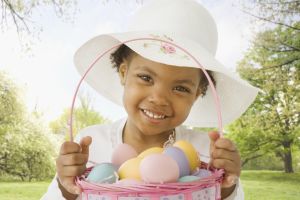 African girl holding Easter basket of eggs