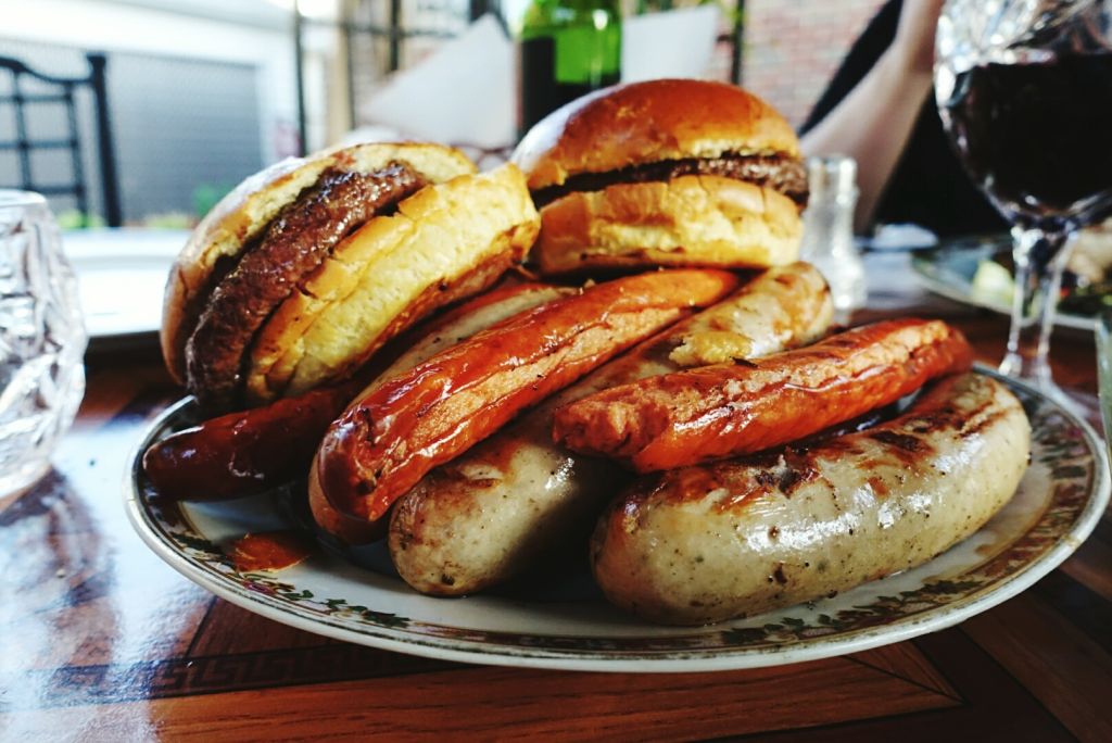 Hamburgers And Sausages On Plate