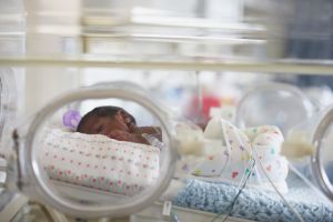 African American baby in hospital incubator