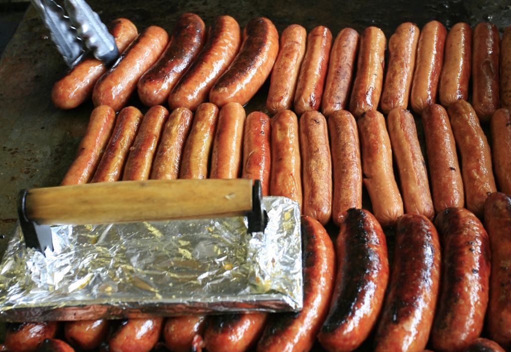 Hot dogs roast on the grill during lunch