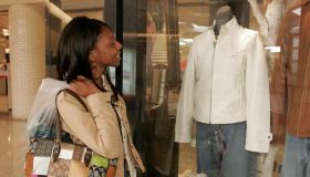 A woman looking a clothes in a store window at Westfield Shoppingtown Southlake.