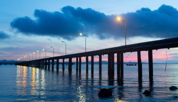 Concrete Pier with Street Lamp over the Sea and Sunrise Sky.