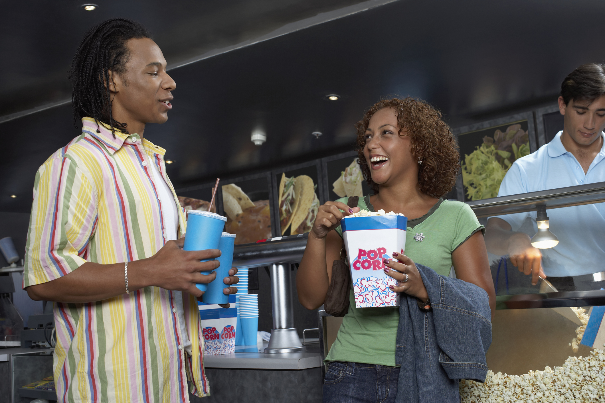 Couple Buying Popcorn and Soda at Movie Theater