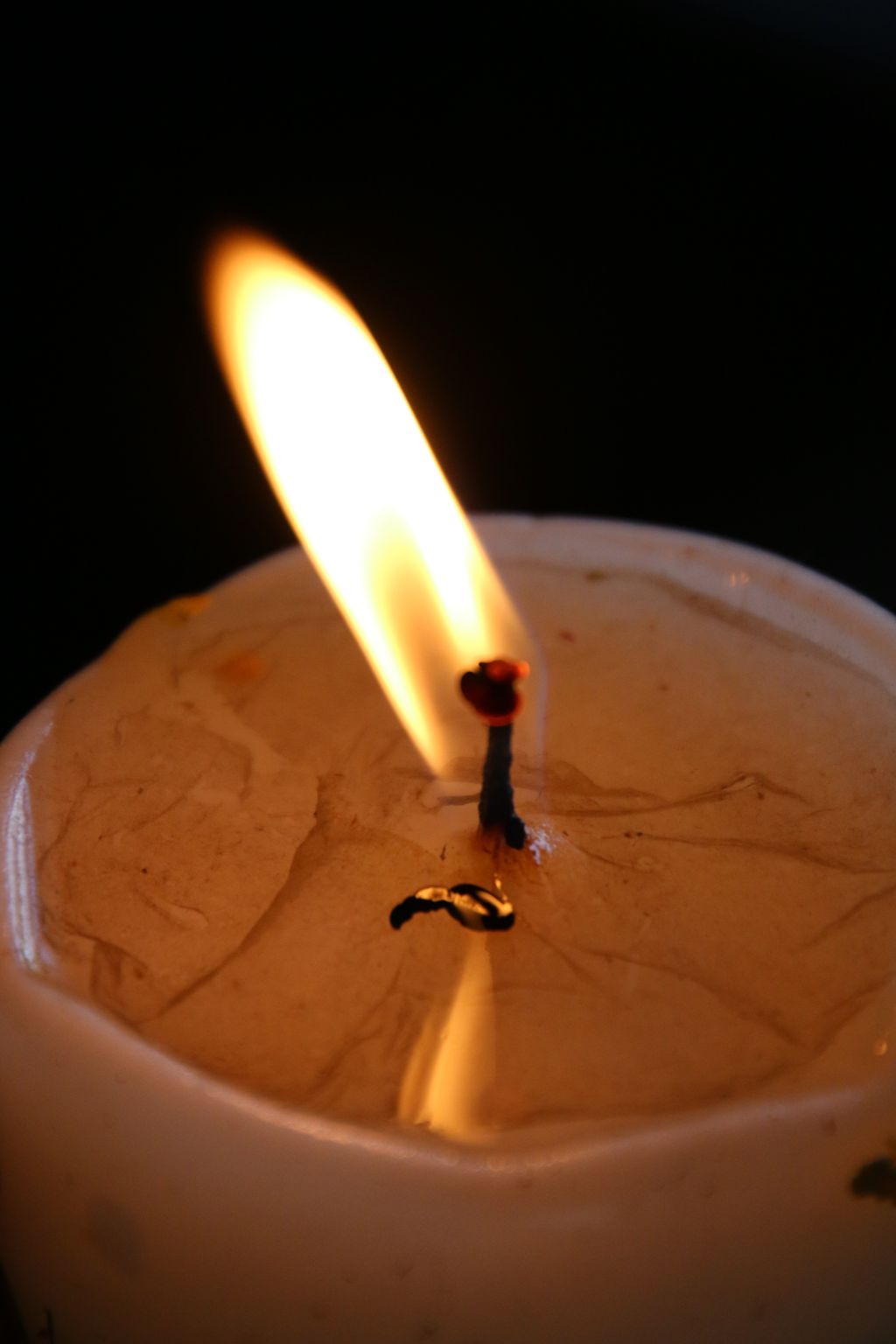 Close-Up Of Burning Candle In Darkroom