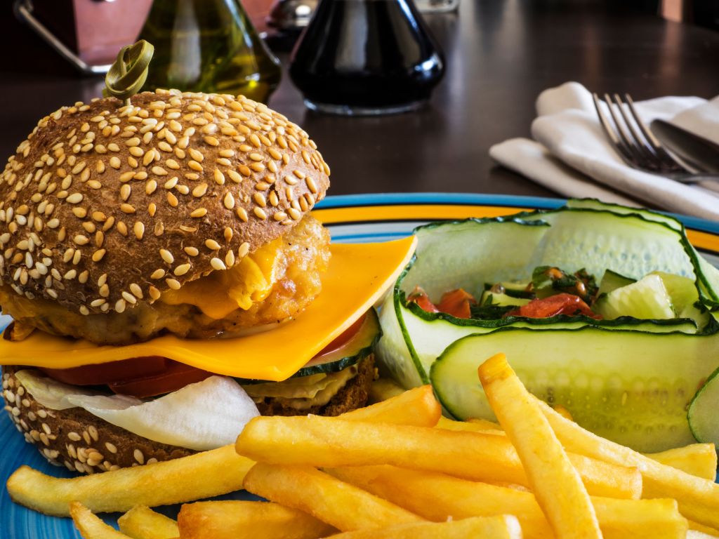 Close-Up Of Cheeseburger With French Fries In Plate