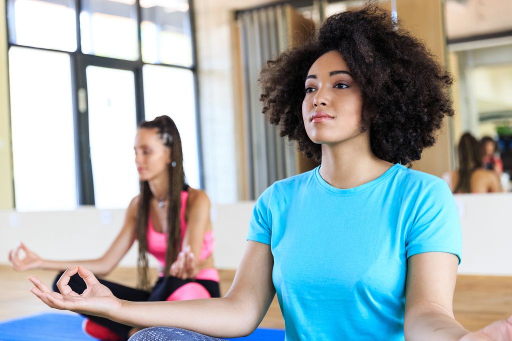 Woman practicing yoga in gym