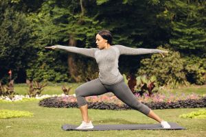 Young woman doing yoga at park