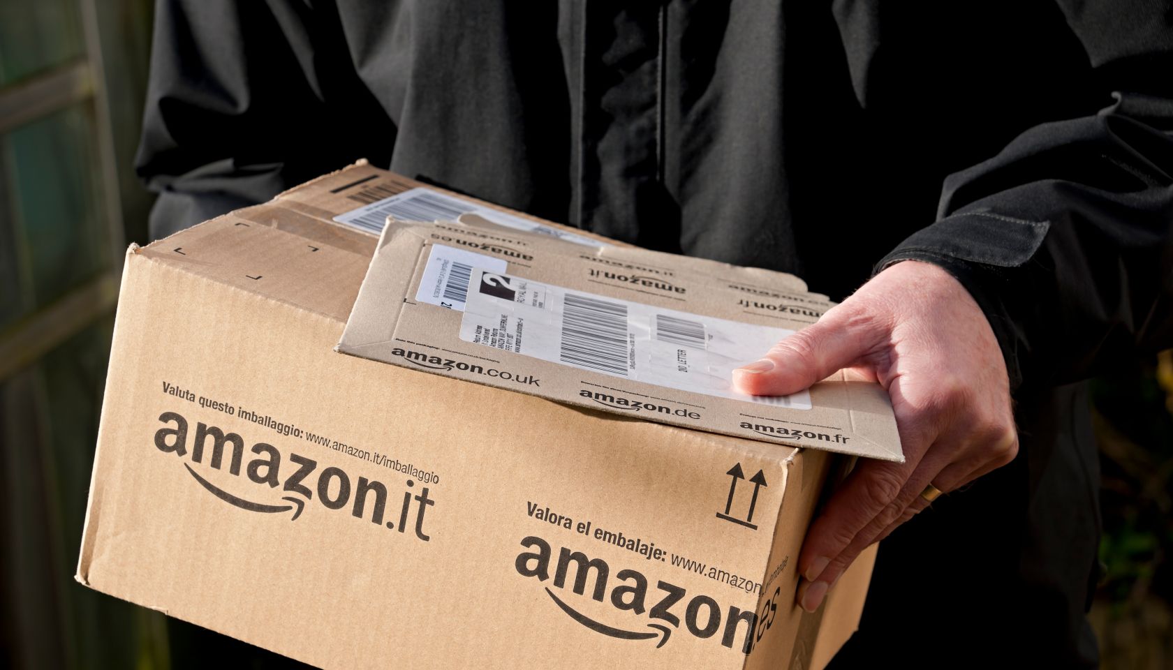 A Man Holding an Amazon Delivery