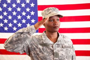 African descent female in military uniform saluting American flag