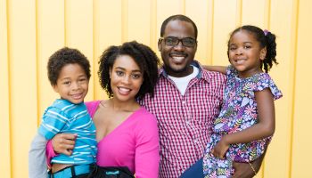 African American family smiling to the camera, portrait