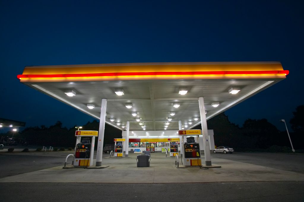 Gas Station with lights on and mini-mart at dusk in Central GA