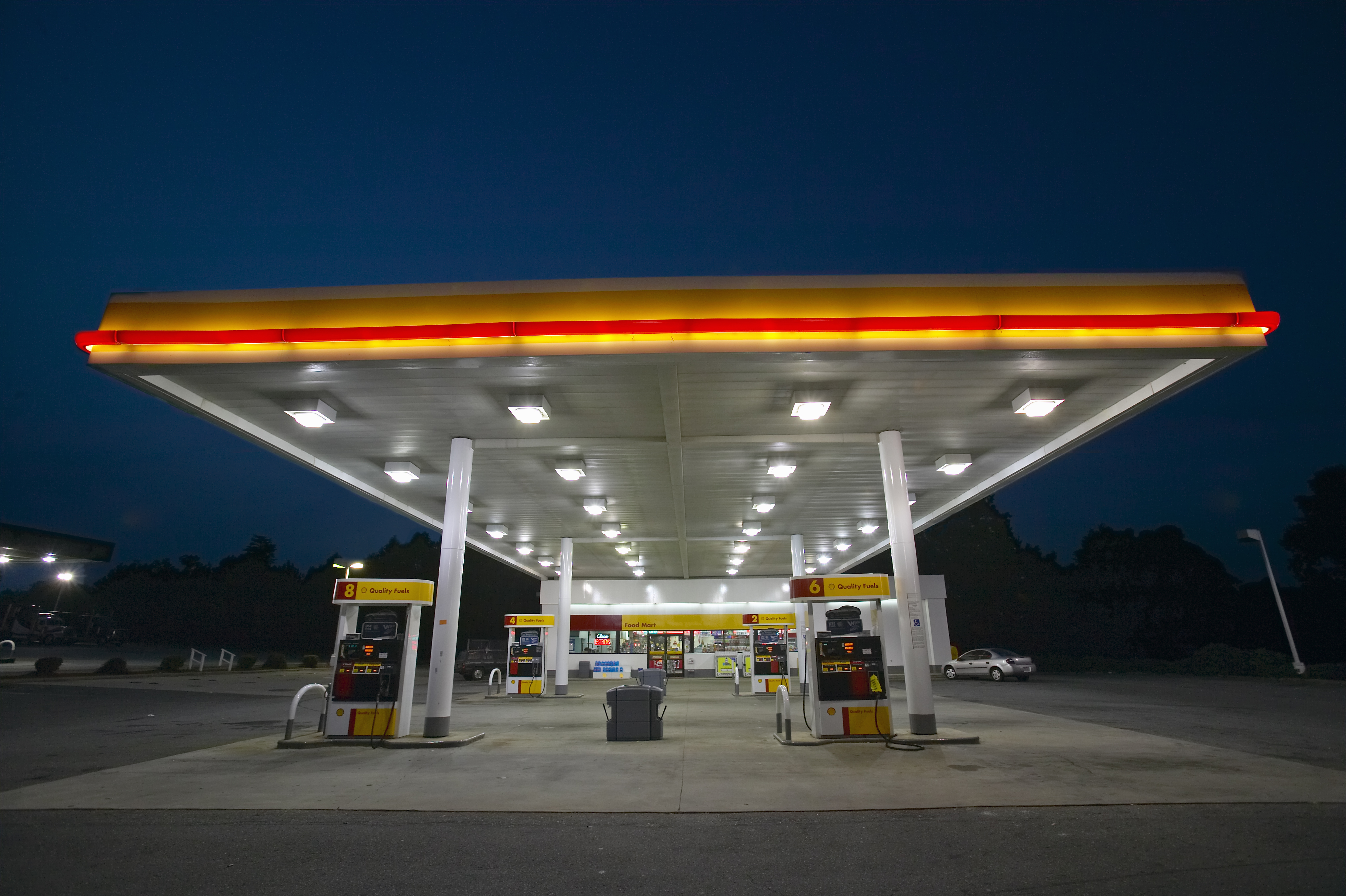 Gas Station with lights on and mini-mart at dusk in Central GA