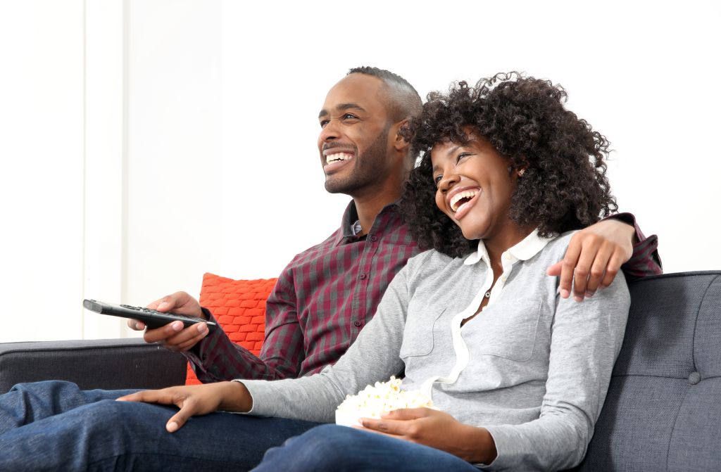 Young couple watching television.