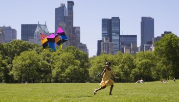 African girl flying kite in park