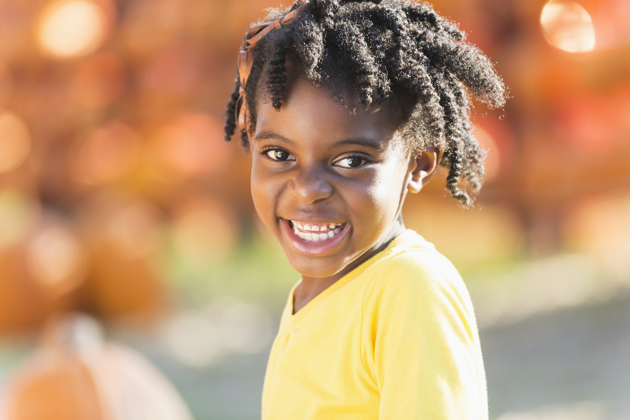 Little African-American girl in a pumpkin patch