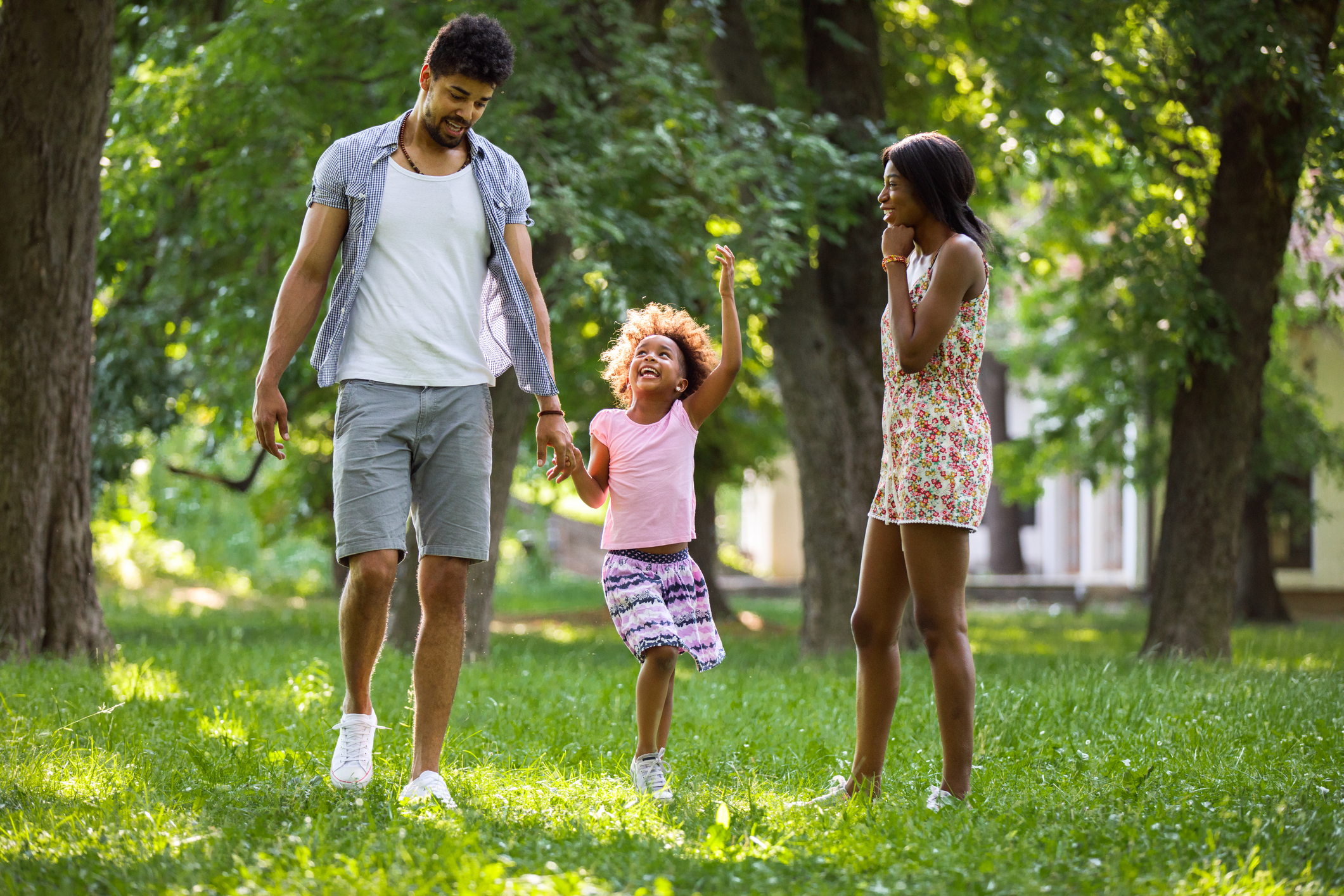 Playful African American family enjoying a day in nature.