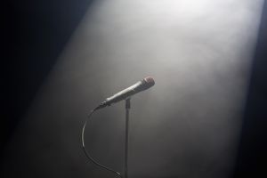 A spot lit microphone stand
