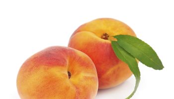 Sweet peaches with leafs on a white background