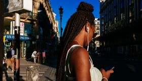 Young afro french woman wearing african braids standing on...