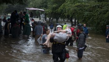 Police and volunteers rescue residents flooded by the San Jacinto river in Kingwood, Texas