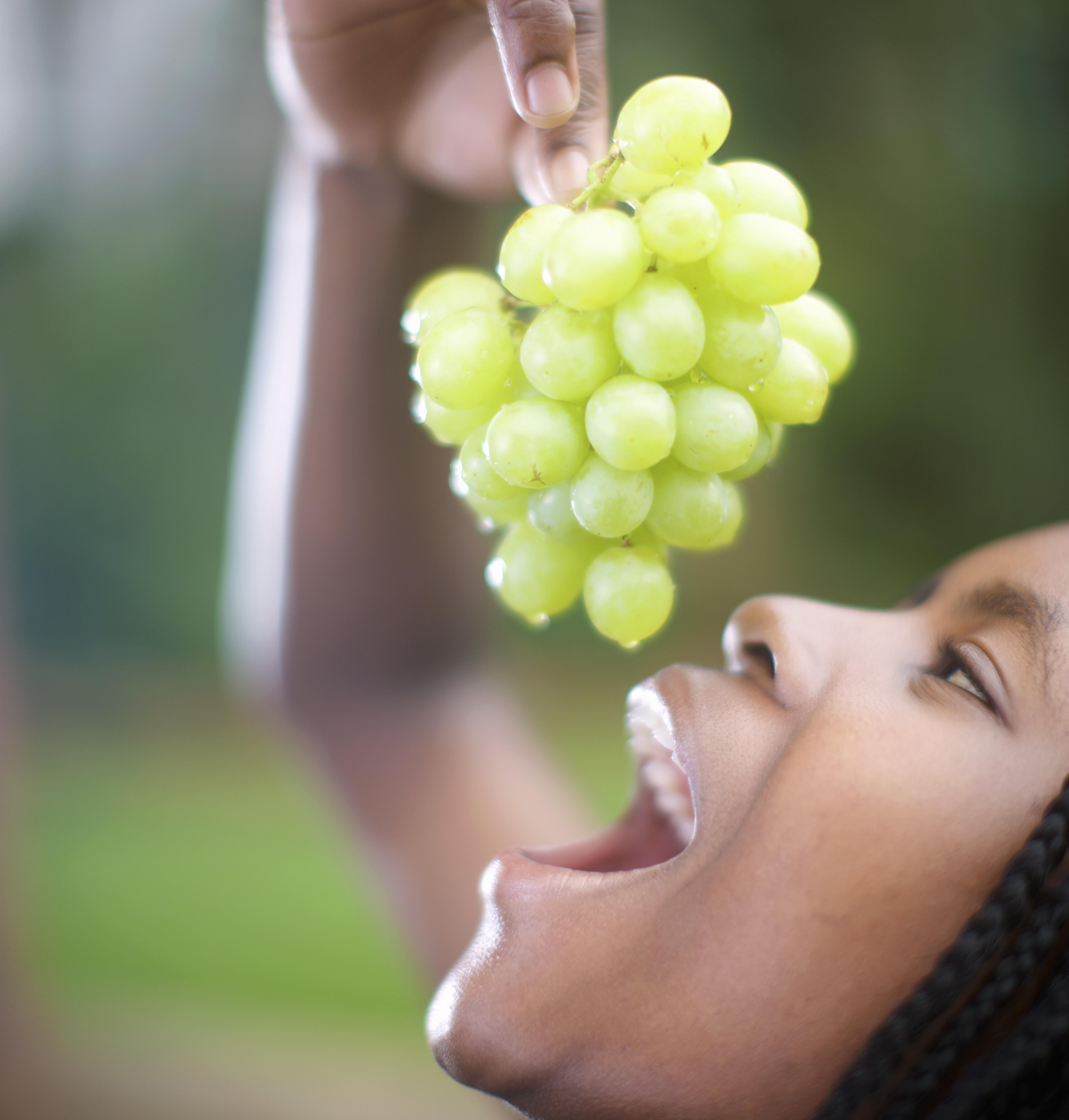 Woman eating grapes, Pietermaritzburg, KwaZulu-Natal Province, South Africa