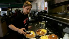 Gaby Estrella (Cq), prepares a tray of Grand Slam breakfast at Denny's Restaurant in Santa Ana on t