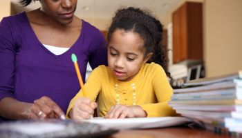 Mom helping daughter with school work.