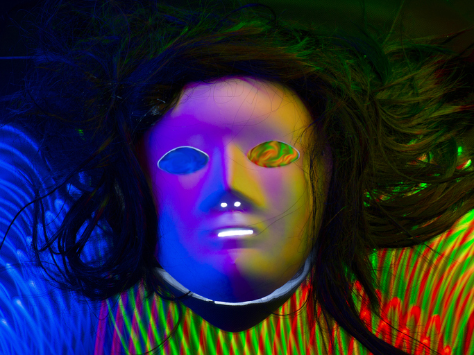 Mask with hair on digital green-red and blue lines forming a lattice in 3D. Light painting