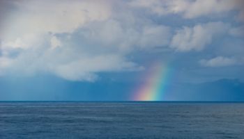 Rainbow over the ocean horizon