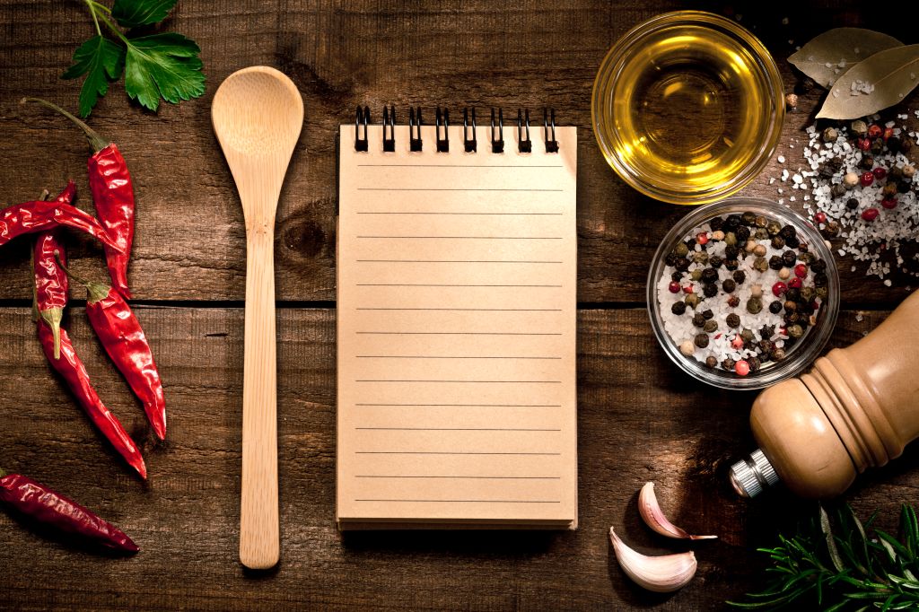 Blank recipe book with herbs and spices