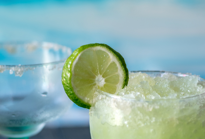 Cold And Icy Frozen Margarita Drinks With Slices Of Lime
