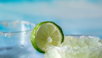 Cold And Icy Frozen Margarita Drinks With Slices Of Lime
